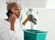Phone,Call,For,Plumbing,Service,,Woman,In,Bathroom,And,Help