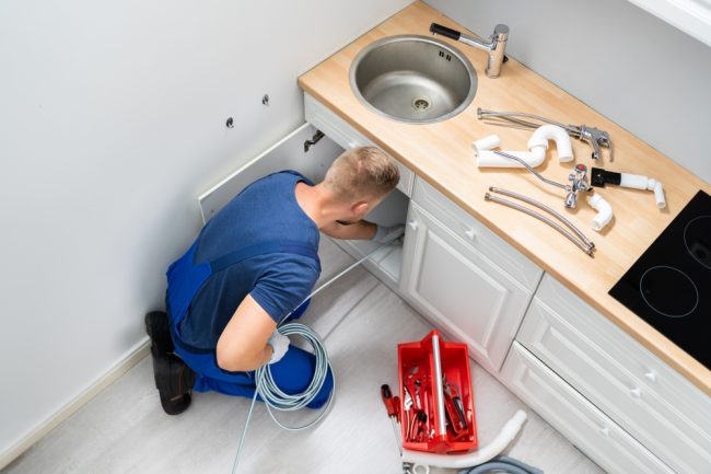 Male,Plumber,Cleaning,Clogged,Sink,Pipe,In,Kitchen