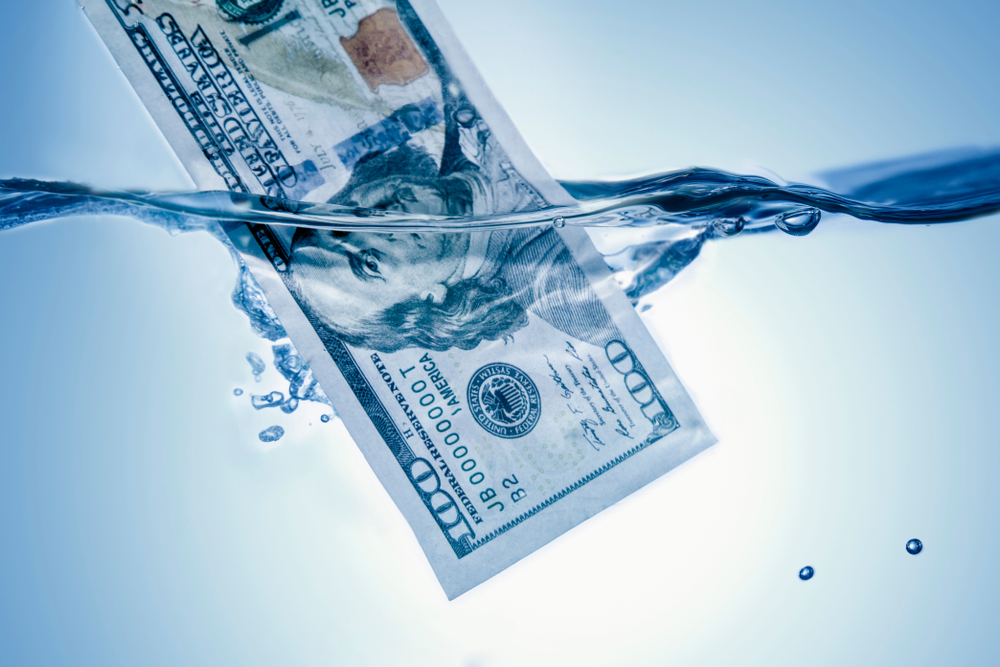Money,Concept.,Us,Dollar,Sinking,In,Water,As,A,Symbol Money,Concept.,Us,Dollar,Sinking,In,Water,As,A,Symbol